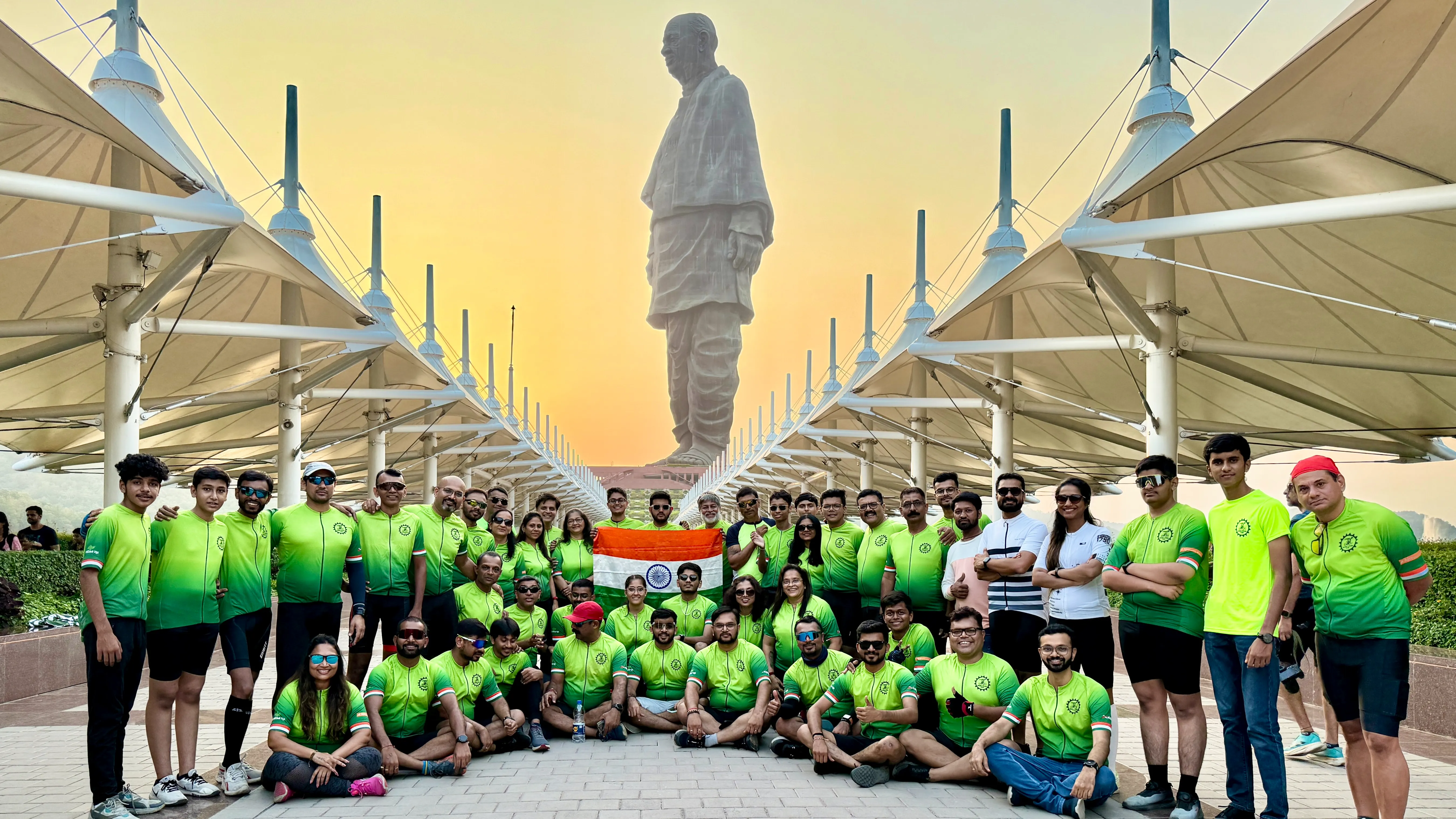 The Anand Cycling Club riders at Statue of Unity holding the Indian flag